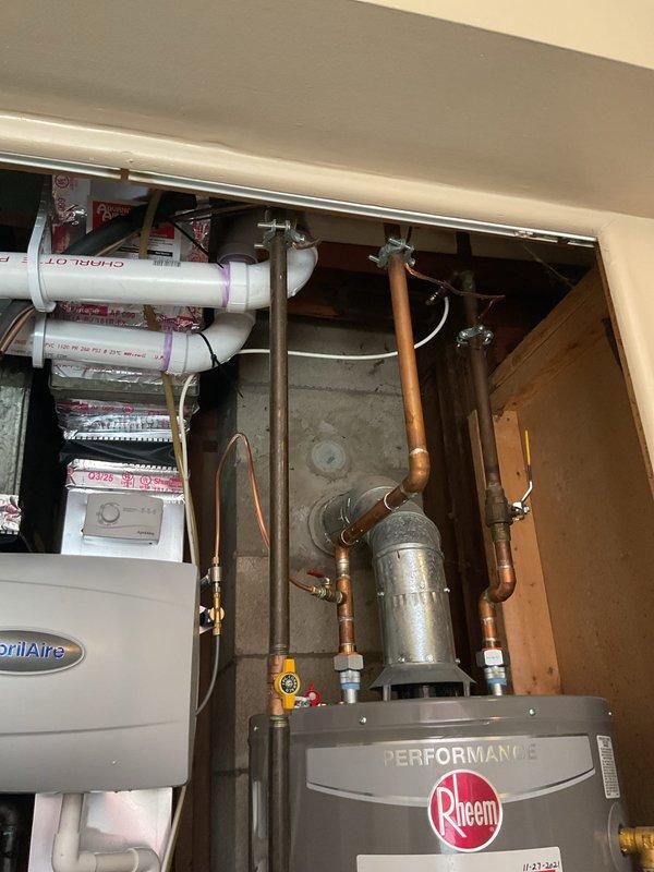 Complete HVAC system installation including 70,000 BTU furnace and 2.5 ton air conditioning unit with rear discharge configuration. Installed new programmable thermostat, AprilAire humidifier, and Filtrete 16x25x4 air filtration system. Completed all necessary PVC venting and condensate drainage piping with proper pitch and connections. Ran electrical wiring and made all required connections to furnace, AC unit, and thermostat. Reconnected existing plumbing and utility connections. Obtained mechanical and electrical permits as required. System tested and operational, meeting AHRI certification standards for matched equipment performance and qualifying for utility rebate program.