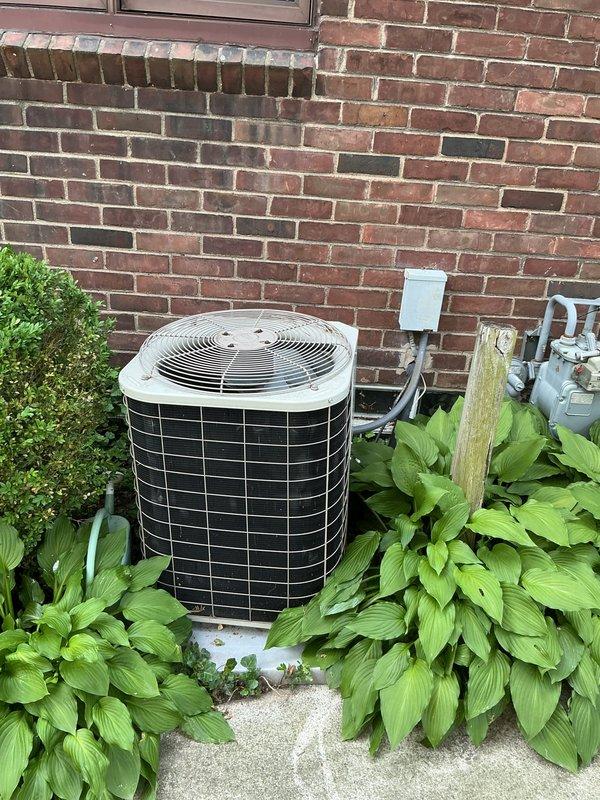 Completed comprehensive estimate for HVAC system replacement at residential property with aging equipment including a 2005 condenser unit and 1995 evaporator coil currently low on R22 refrigerant. Assessment included evaluation of existing cylindrical air conditioning condenser positioned on concrete pad against exterior brick wall, basement-located air handler/coil assembly, and malfunctioning humidifier system requiring replacement. Documented equipment conditions through photographic inspection and provided replacement recommendations for complete system upgrade to address refrigerant phase-out concerns and resolve ongoing humidifier issues.