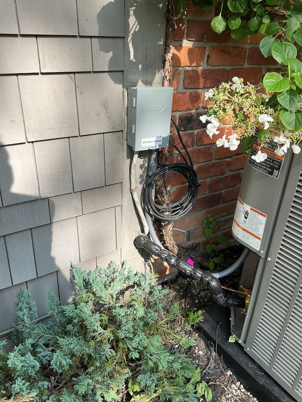 Completed full installation of 3-ton air conditioning system with matching evaporator coil in left side yard location. Installed new outdoor condensing unit in narrow space between brick wall and building exterior, mounted electrical disconnect box with proper conduit routing, and connected refrigerant lines. Installed air handler with new evaporator coil in attic space, replaced condensate drain pan as needed, installed wet switch for overflow protection, and flushed refrigerant lines prior to system startup. Secured all necessary mechanical and electrical permits, verified proper system operation, and confirmed all components functioning to manufacturer specifications.