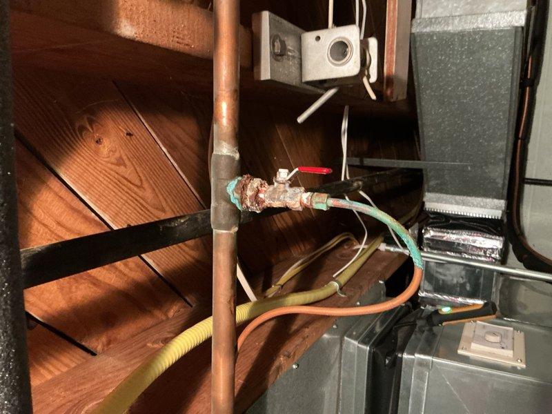 Completed comprehensive Gold AC Inspection and routine maintenance on a 10-year-old General Electric outdoor air conditioning unit. Performed standard tune-up procedures including system diagnostics, refrigerant level verification, electrical connection inspection, and condenser coil assessment. Inspected indoor components including copper refrigerant lines and associated valves, noting corrosion and oxidation present on valve connections that should be monitored for future service needs. All refrigerant hoses and connections were examined and found secure. System operational testing confirmed unit is functioning within normal parameters with no immediate issues requiring repair at this time.
