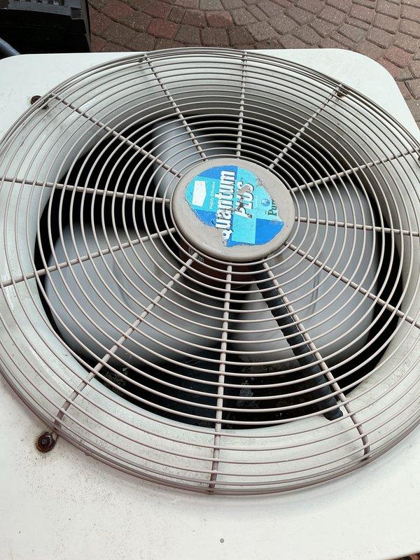 Performed comprehensive inspection and tune-up on Pabon brand outdoor condensing unit. Unit found in functional condition with fan assembly operating properly and protective grille intact. Verified proper placement on concrete pad, noted minor vegetation growth in surrounding gravel area that should be monitored to prevent airflow obstruction.