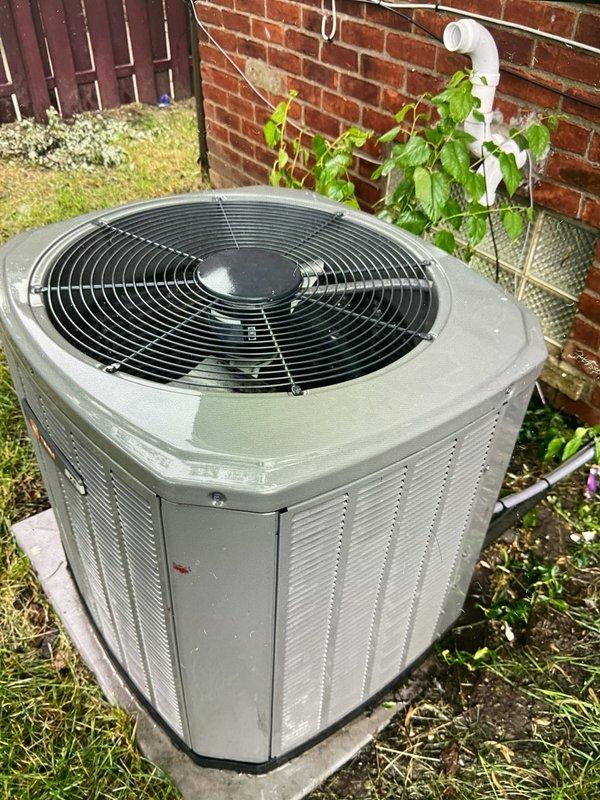 Responded to service call for thermostat displaying fault code on 10+ year old residential cooling system. Performed comprehensive inspection of outdoor condenser unit and electrical components. Examined contactor assembly, verified wiring connections on all terminals, and assessed overall system condition. Unit found operational with accumulation of dust and debris on electrical components. Documented equipment condition with photos showing condenser placement, electrical contactor with specifications (XMCC-32T model, 24VAC coil, 32 FLA rating), and wiring configuration including power and control circuits.