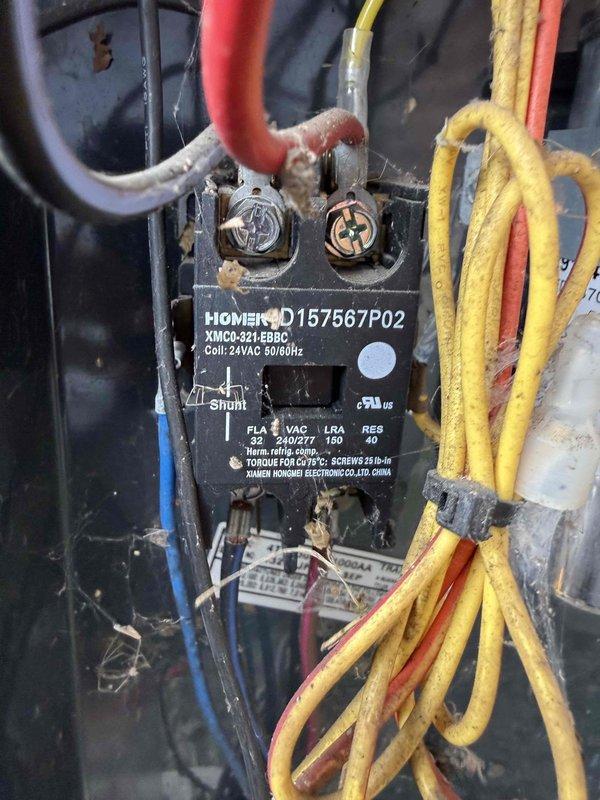 Responded to service call for thermostat displaying fault code on 10+ year old residential cooling system. Performed comprehensive inspection of outdoor condenser unit and electrical components. Examined contactor assembly, verified wiring connections on all terminals, and assessed overall system condition. Unit found operational with accumulation of dust and debris on electrical components. Documented equipment condition with photos showing condenser placement, electrical contactor with specifications (XMCC-32T model, 24VAC coil, 32 FLA rating), and wiring configuration including power and control circuits.