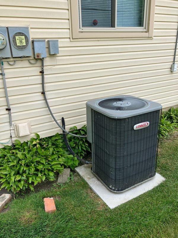 Completed estimate for air conditioning system replacement at residential property. Existing Lennox outdoor condensing unit is 26 years old and located on concrete pad in backyard, requiring replacement due to age and end of serviceable life. Assessed indoor air handler and ductwork in basement utility area, evaluated electrical service connections and conduit routing from exterior meters, and provided comprehensive replacement options for complete HVAC system upgrade.