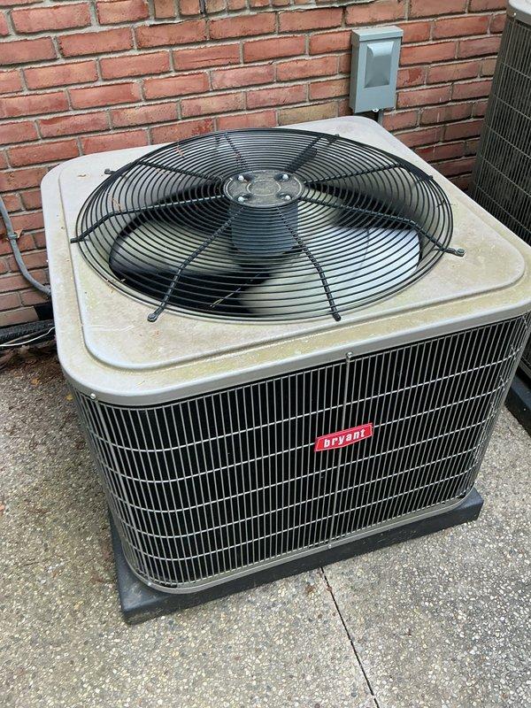 Completed comprehensive Gold AC inspection on residential property with three air conditioning units, including one Bryant and one Lennox condensing unit located exterior on concrete pads, with air handler/coil assembly positioned in basement. Performed thorough visual assessment of all accessible components, verified operational status of equipment less than 10 years old, and documented unit conditions through photographic evidence. Inspected exterior condensing units for proper airflow clearances, examined mounting pads and electrical disconnect boxes, assessed cabinet integrity and louver vent conditions, and verified fan guard assemblies were intact. Noted minor dirt accumulation on equipment surfaces consistent with normal outdoor exposure and identified debris around condenser base areas requiring clearance to maintain optimal performance and prevent airflow restrictions.