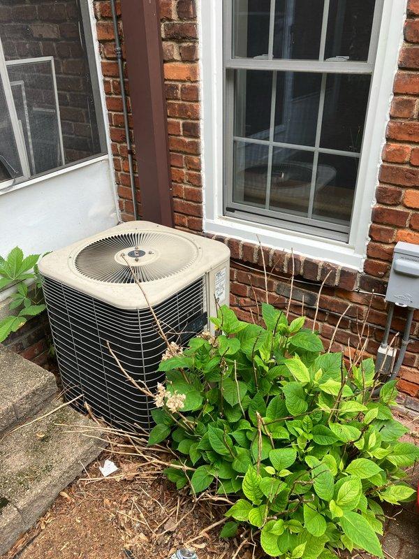 Completed comprehensive estimate for full HVAC system replacement of existing 20-year-old air conditioning equipment. Evaluated outdoor condenser unit positioned on concrete pad against brick foundation and corresponding attic-mounted air handler. Documented current system configuration, assessed installation requirements, and photographed existing equipment placement and surrounding conditions to provide accurate replacement proposal for new cooling system.