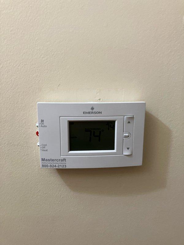 Provided replacement estimate for 15-year-old air conditioning system that is barely operational. Unit is located in basement and operates in conjunction with natural gas furnace. Evaluated existing Emerson programmable thermostat, exterior disconnect box, and conduit routing to determine replacement specifications and requirements for new HVAC equipment installation.