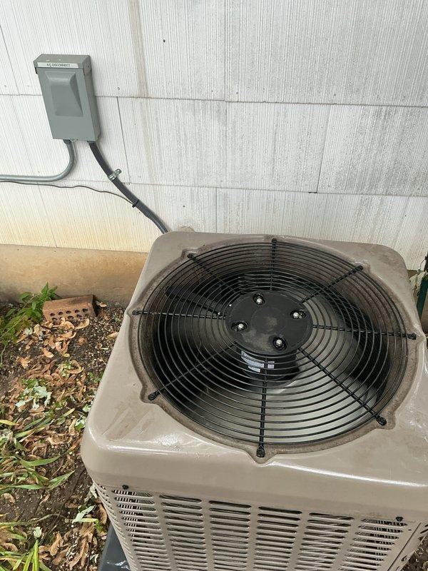 Completed comprehensive Gold AC Inspection on residential outdoor condensing unit over 10 years old with air handler attached to furnace. Performed visual inspection of condenser cabinet, fan assembly, refrigerant lines, electrical disconnect, and internal components including valves and copper tubing. Unit confirmed operational at time of inspection with all major components functioning as designed.