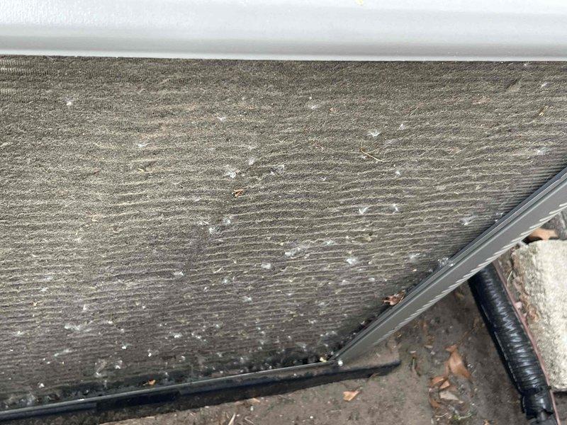 Completed comprehensive Gold AC Inspection on a 1-year-old air conditioning system located in the utility room. Performed thorough examination of evaporator coil, noting moderate dust and debris accumulation on coil fins with some organic matter present. Inspected air filtration system, observing moderately soiled filter media with visible dust and particle buildup but no structural damage to filter or frame. All components photographed and documented for maintenance records, with system operational at time of inspection.
