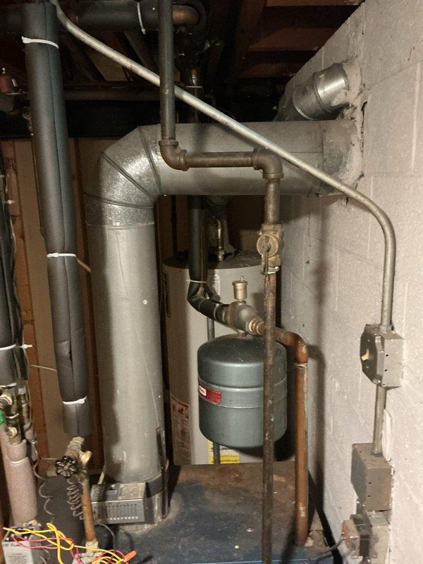 Performed comprehensive boiler inspection in basement mechanical room for new homeowner. Conducted visual assessment of boiler system, expansion tank, venting components, and associated plumbing connections. Verified proper operation of heating equipment, examined ductwork connections, inspected gas piping and safety controls, and documented system condition with photographs for homeowner records.