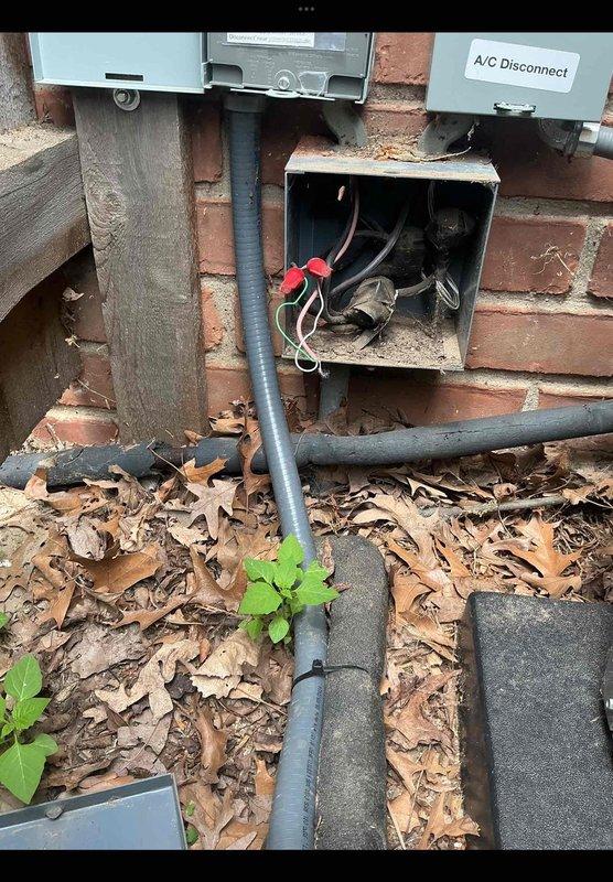 Responded to no-cooling call on 2-month-old residential AC system located in basement. Upon arrival, found outdoor condensing unit installed against brick wall with proper clearances and copper linesets in place. Investigated electrical connections at exterior disconnect and confirmed power supply to unit. Identified tripped breaker at electrical panel as root cause of system failure. Reset breaker, verified proper voltage at disconnect, and cycled system through complete operational test. Confirmed condenser fan motor operation, compressor startup, and normal amperage draw on all components. System restored to full cooling operation with no further issues detected.