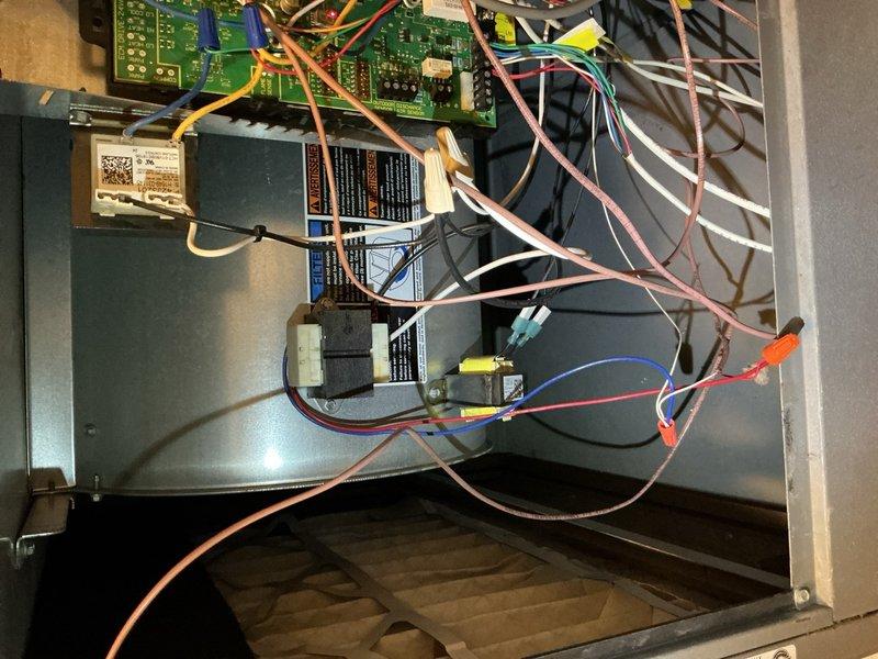 Responded to callback for rooftop Lennox unit experiencing intermittent cooling failure and blank thermostat display. Upon inspection, accessed control board and wiring compartment to diagnose electrical issues. Performed voltage testing and verified circuit board functionality using diagnostic equipment, reading 42V at test points. Identified temperature sensor/frost sensor as failed component causing system shutdown during operation. Ordered replacement temp sensor under PO 1329651-001 for installation upon arrival at shop. Documented internal wiring configuration and control board layout for follow-up repair visit.