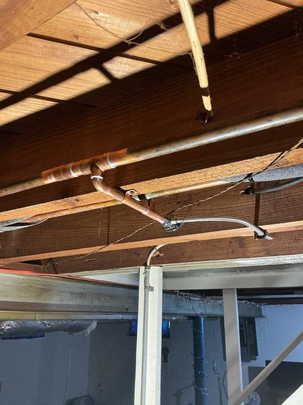 Installed new ice maker supply line from basement plumbing to refrigerator location. Routed flexible braided stainless steel water line through ceiling joists and connected to existing copper water supply system with appropriate fittings and shut-off valve for future service access.