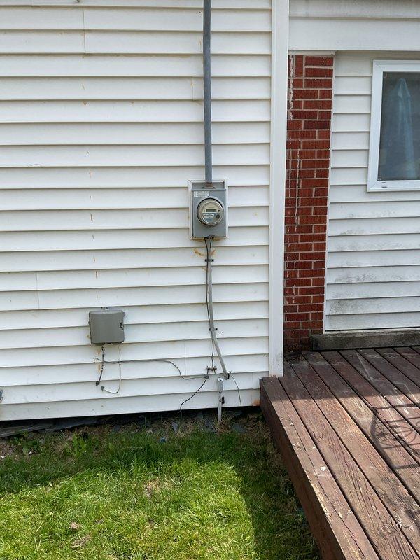 Completed full HVAC system installation including a 70,000 BTU furnace, 2-ton air conditioning unit, programmable thermostat, and humidifier at residential property. Equipment was installed in rear yard location with condenser unit positioned on exterior wall alongside existing electrical service infrastructure. All electrical disconnects and conduit were properly installed and routed along exterior siding to meet code requirements. New PVC condensate drain lines were run through exterior wall for proper drainage. Mechanical, electrical, and furnace permits were obtained prior to installation. System was connected to existing ductwork and electrical service, with all reconnections completed per manufacturer specifications. Unit qualifies for utility company energy efficiency rebates and carries AHRI certification number 215663144. Final testing confirmed proper operation of heating, cooling, and humidification functions with all safety controls verified operational.