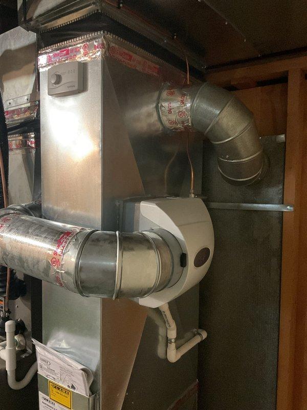 Completed full HVAC system installation including 45,000 BTU furnace, 2-ton air conditioning unit with rear discharge configuration, programmable thermostat, humidifier, and condensate pump. Installed all required ductwork connections with proper sealing at joints, mounted humidifier assembly on furnace cabinet with drainage line, and reconnected existing electrical service. Mechanical permit obtained for furnace and AC installation only. System tested for proper operation, airflow verified, and thermostat programmed. Customer registered for available utility rebate programs totaling combined savings. All equipment installed per manufacturer specifications and local code requirements, with photo documentation completed for record retention.
