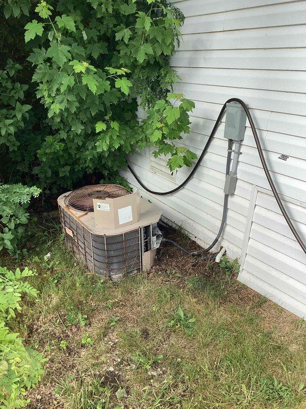Provided comprehensive replacement estimate for non-operational residential air conditioning system over 10 years old, including outdoor condenser unit and indoor natural gas furnace located in utility room. Assessed existing equipment configuration, photographed current installation showing outdoor condenser with refrigerant line routing and indoor furnace with blower assembly and ductwork connections. Reviewed system specifications and discussed replacement options to restore cooling and heating functionality for the home.
