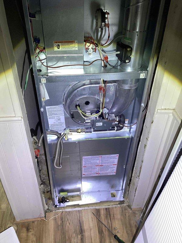 Provided comprehensive replacement estimate for non-operational residential air conditioning system over 10 years old, including outdoor condenser unit and indoor natural gas furnace located in utility room. Assessed existing equipment configuration, photographed current installation showing outdoor condenser with refrigerant line routing and indoor furnace with blower assembly and ductwork connections. Reviewed system specifications and discussed replacement options to restore cooling and heating functionality for the home.