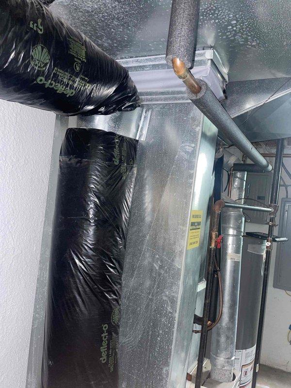 Responded to service call for air conditioning unit check-up in basement location. Upon inspection, diagnosed locked compressor on unit less than one year old. Provided detailed replacement estimate for complete AC system due to compressor failure. Documented existing HVAC installation including ductwork configuration, refrigerant lines, and mechanical connections for replacement specifications.