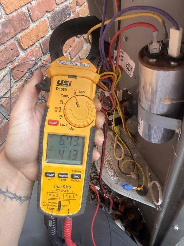 Responded to service call for 5.5-year-old outdoor AC unit with inadequate cooling capacity affecting entire home. Upon arrival, performed comprehensive electrical diagnostics using digital clamp meter to measure amperage draw and voltage at compressor and capacitor connections. Testing revealed abnormal electrical readings indicating potential compressor or capacitor failure. Documented equipment condition and electrical measurements with photos for service records. Provided customer with diagnostic findings and recommended repair options to restore proper cooling operation.