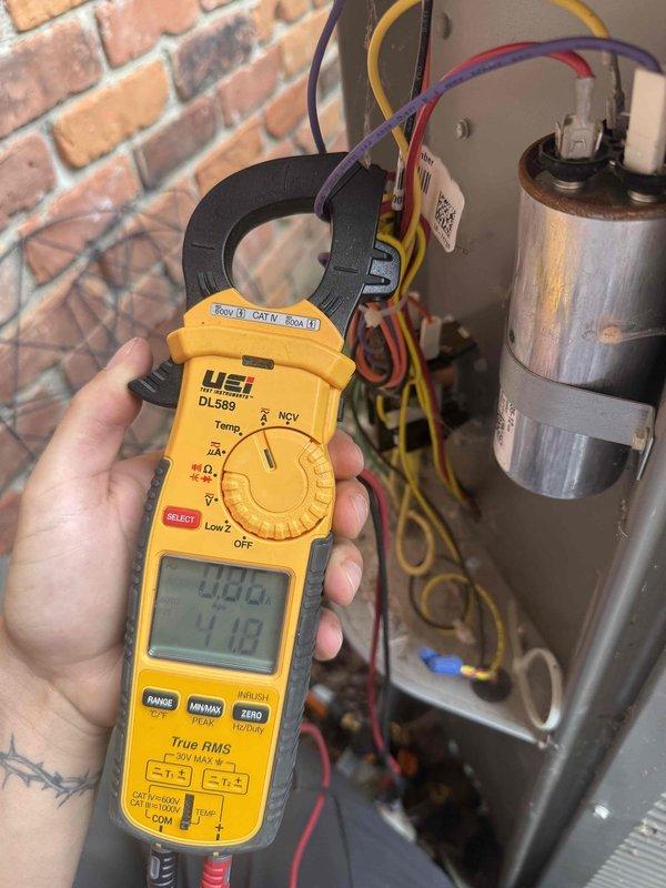 Responded to service call for 5.5-year-old outdoor AC unit with inadequate cooling capacity affecting entire home. Upon arrival, performed comprehensive electrical diagnostics using digital clamp meter to measure amperage draw and voltage at compressor and capacitor connections. Testing revealed abnormal electrical readings indicating potential compressor or capacitor failure. Documented equipment condition and electrical measurements with photos for service records. Provided customer with diagnostic findings and recommended repair options to restore proper cooling operation.