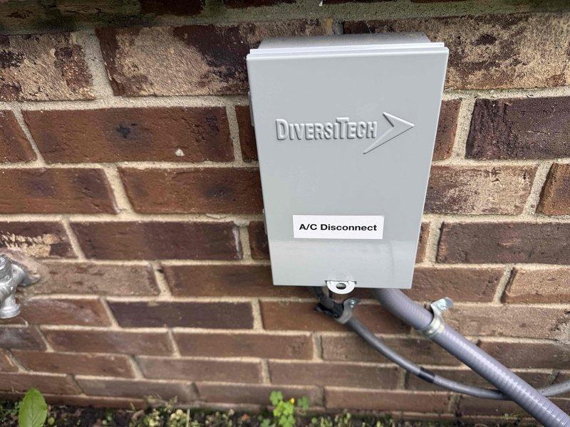 Responded to service call for AC unit located in basement making short grinding, loud buzzing noise prior to system startup. Upon arrival, performed complete system diagnostic including inspection of outdoor disconnect, contactor operation, and compressor function. Verified thermostat communication and cooling cycle initiation at 72-degree setpoint. Inspected electrical connections at exterior disconnect box and confirmed proper conduit installation and secure mounting. Evaluated compressor startup sequence and monitored for abnormal sounds during initial energization phase. System currently operating and achieving target temperature, though intermittent noise at startup may indicate early-stage contactor wear or capacitor degradation requiring future monitoring.
