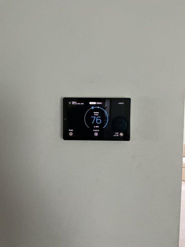 Responded to service call for AC unit located in basement making short grinding, loud buzzing noise prior to system startup. Upon arrival, performed complete system diagnostic including inspection of outdoor disconnect, contactor operation, and compressor function. Verified thermostat communication and cooling cycle initiation at 72-degree setpoint. Inspected electrical connections at exterior disconnect box and confirmed proper conduit installation and secure mounting. Evaluated compressor startup sequence and monitored for abnormal sounds during initial energization phase. System currently operating and achieving target temperature, though intermittent noise at startup may indicate early-stage contactor wear or capacitor degradation requiring future monitoring.