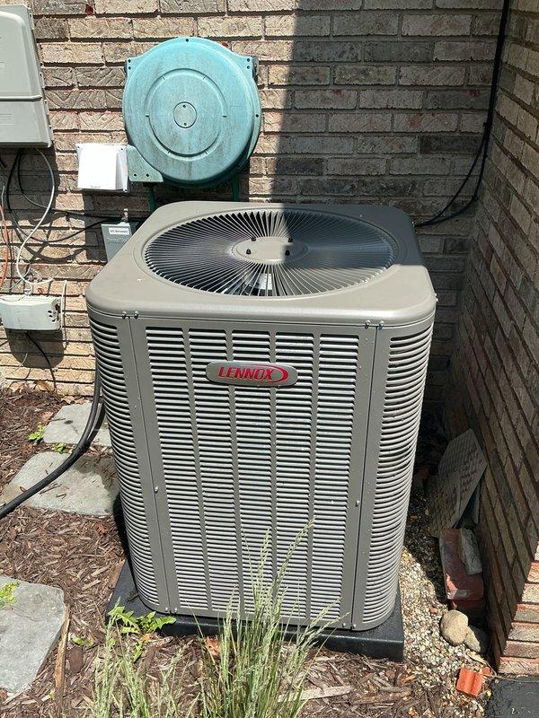 Completed comprehensive Gold AC Inspection on two residential Lennox air conditioning systems, both under 10 years of age and operating properly at time of service. Performed thorough multi-point inspection on both outdoor condenser units positioned against exterior brick wall, each mounted on concrete pads with proper clearance. Inspected electrical disconnect boxes, conduit connections, and verified secure mounting of all components. Evaluated fan operation, louver venting systems, and overall unit condition on both condensers. Confirmed air handler and coil assembly located in basement. Both systems demonstrated normal operational parameters with no deficiencies noted requiring immediate attention.