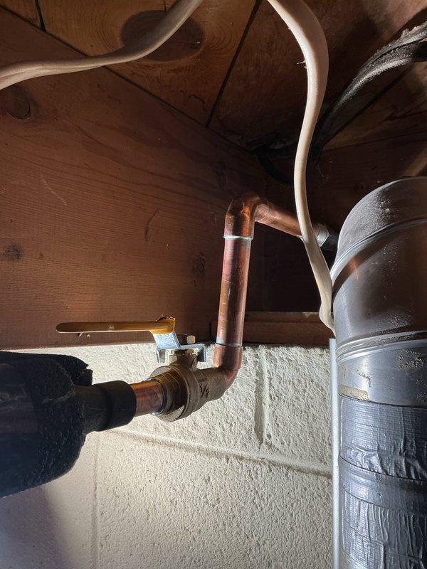 Replaced frost-free hose bib in attic crawl space, installing new copper pipe connections and brass valve assembly. Completed all soldered joints and verified proper operation of the new fixture to restore exterior water access.
