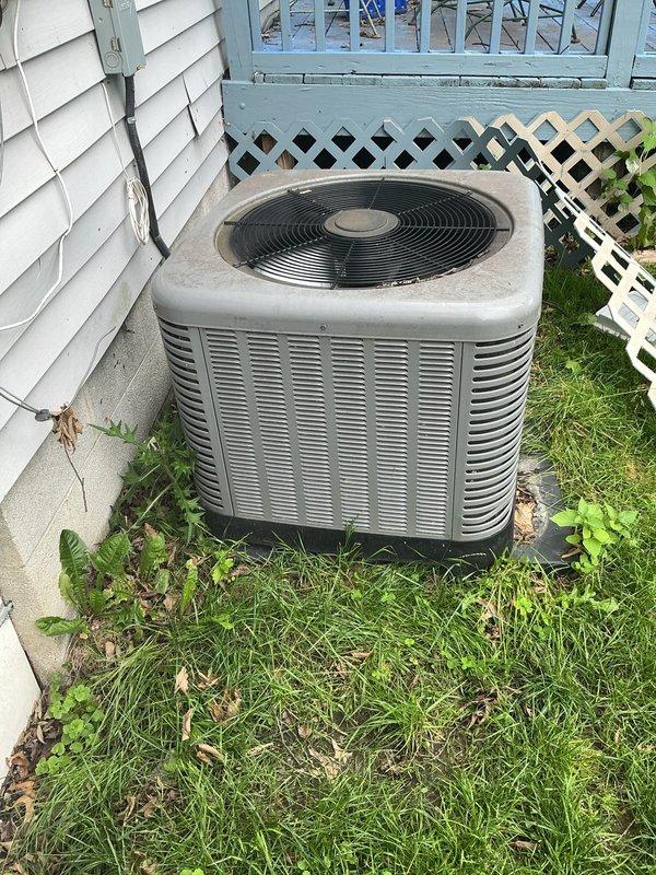 Responded to service call for AC condenser unit damaged by fallen tree. Performed comprehensive visual inspection of 15-year-old unit exterior, cabinet, fan assembly, coil fins, and refrigerant lines for impact damage. Unit had shifted from original position on concrete pad. Assessed structural integrity of cabinet, verified no visible refrigerant leaks, checked electrical connections and conduit for damage. Documented unit condition with photographs showing weathered cabinet with dirt accumulation but no apparent structural compromise to major components. Unit repositioned back onto original concrete pad location and leveled on mounting feet.