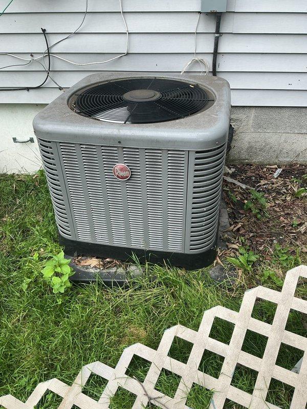 Responded to service call for AC condenser unit damaged by fallen tree. Performed comprehensive visual inspection of 15-year-old unit exterior, cabinet, fan assembly, coil fins, and refrigerant lines for impact damage. Unit had shifted from original position on concrete pad. Assessed structural integrity of cabinet, verified no visible refrigerant leaks, checked electrical connections and conduit for damage. Documented unit condition with photographs showing weathered cabinet with dirt accumulation but no apparent structural compromise to major components. Unit repositioned back onto original concrete pad location and leveled on mounting feet.