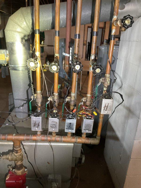 Completed scheduled furnace maintenance and heating system tune-up per customer request. System was operating properly upon arrival. Performed comprehensive inspection of HVAC control components including Honeywell RA89A control unit, electrical relays, and multiple transformers. Inspected multi-zone hydronic heating manifold system with individual zone valves and copper piping distribution. Verified proper operation of all zone controls, electrical connections, and associated wiring. All components found to be functioning within normal parameters with no immediate service needs identified.