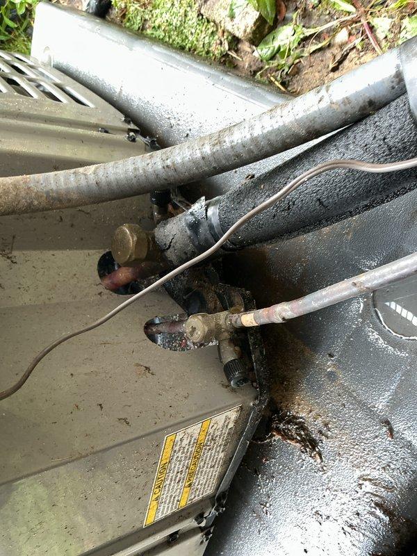 Completed comprehensive Gold AC Inspection and preventive maintenance on outdoor residential air conditioning system. Performed multi-point inspection including refrigerant line evaluation, condenser coil cleaning, fan motor operation verification, electrical connection testing, and amperage readings. All refrigerant lines with foam insulation showed proper installation with normal condensation present; brass valves and connections inspected and found secure. Condenser unit housing, fan assembly, and protective wire guard examined and confirmed in good working condition. System operating within manufacturer specifications with no deficiencies noted at time of service.