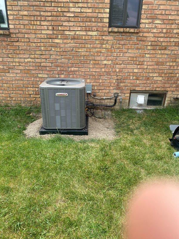 Completed installation of a 2.5-ton Lennox air conditioning system with evaporator coil in rear yard location. Removed both existing AC pads and set new condensing unit on fresh concrete pad with proper gravel base. Ran refrigerant lines to house, performed reconnection of electrical and refrigerant circuits, and coordinated with electrician for final power hookup. System tested and operational upon completion, with AC permit requested for inspection.