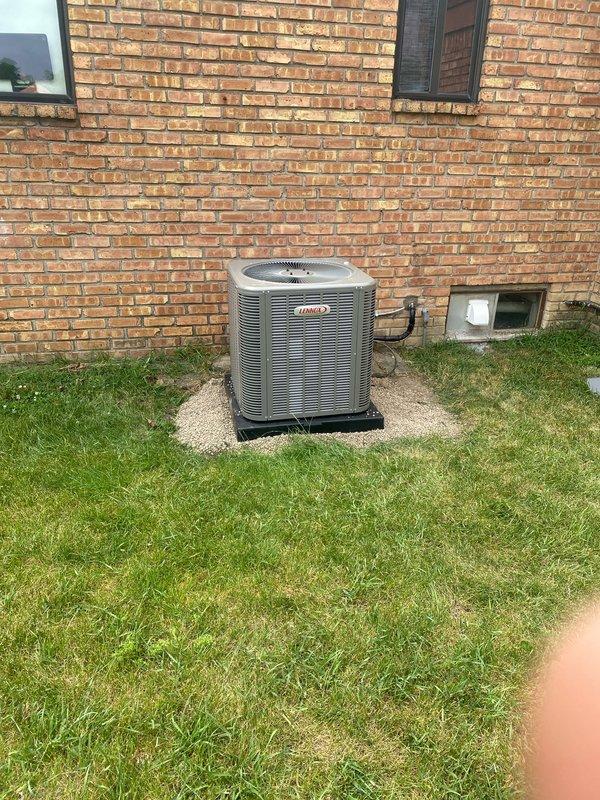Completed installation of a 2.5-ton Lennox air conditioning system with evaporator coil in rear yard location. Removed both existing AC pads and set new condensing unit on fresh concrete pad with proper gravel base. Ran refrigerant lines to house, performed reconnection of electrical and refrigerant circuits, and coordinated with electrician for final power hookup. System tested and operational upon completion, with AC permit requested for inspection.