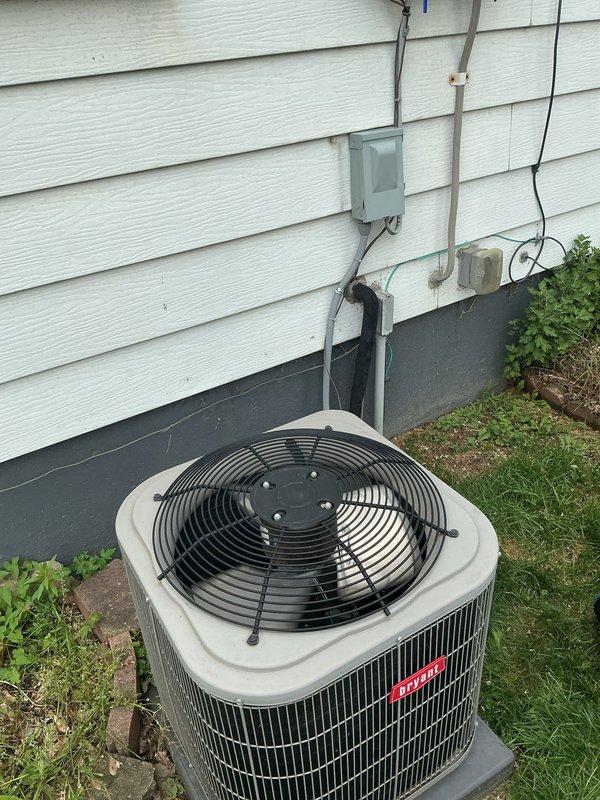 Responded to no cooling complaint with reported loud humming noise and stopped blades on 8-year-old residential AC unit located at basement installation. Upon inspection, diagnosed failed condenser fan motor preventing proper airflow and heat rejection. Replaced defective fan motor and capacitor, verified proper electrical connections at outdoor unit and junction box. Tested system operation, confirmed normal compressor function, proper fan blade rotation, and adequate cooling performance. Unit returned to full operational status.
