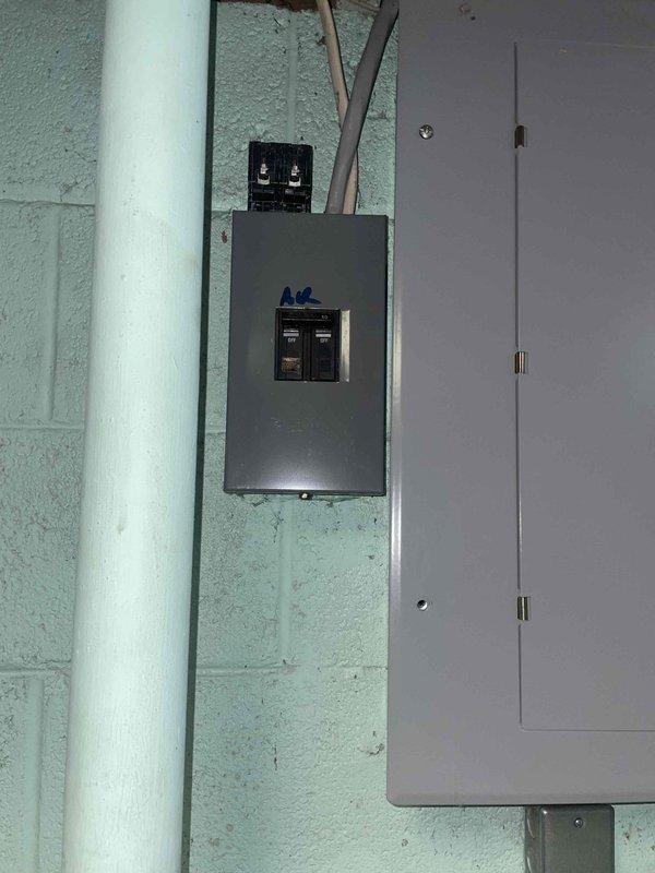 Provided comprehensive estimate for complete air conditioning system replacement for aging 10+ year old unit located in basement. Assessed existing equipment configuration including dedicated A/C electrical disconnect, evaluated natural gas furnace compatibility for new system installation, and documented current thermostat setup displaying 84°F ambient temperature. Presented replacement options and pricing for new cooling system to address customer's inquiry regarding available equipment packages.