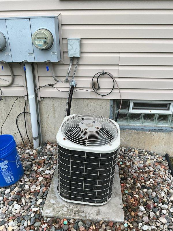 Completed comprehensive Gold AC Inspection on 24-year-old residential air conditioning system with air handler located in basement. Performed full system evaluation including visual inspection of outdoor condenser unit, electrical disconnect box, and associated electrical components. Verified proper operation of all system components, inspected electrical connections and wiring at disconnect, confirmed condenser unit condition and clearances around equipment. System found to be operational at time of inspection with all safety disconnects functioning properly.