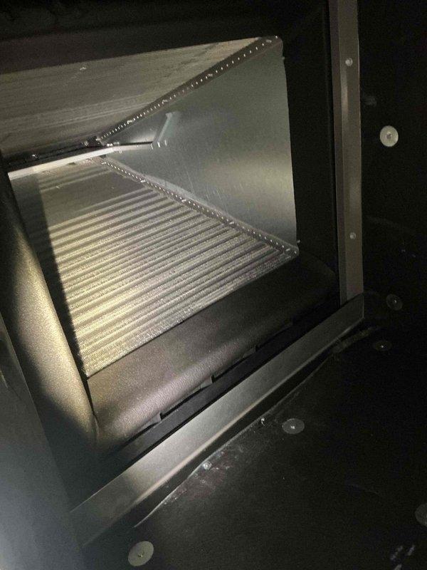 Responded to callback for no cooling issue on 2-year-old AC system located in basement. Performed thorough inspection of evaporator coil and air handler assembly, verified proper airflow through heat exchanger fins, and confirmed system operation. Thermostat displaying 73°F and functioning correctly at time of service visit.
