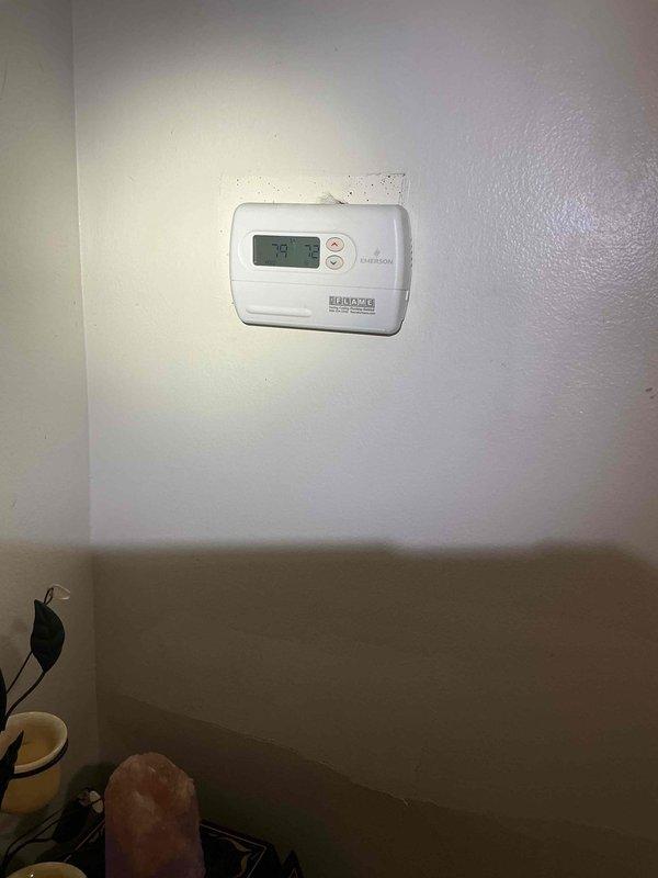 Responded to callback for no cooling issue on 2-year-old AC system located in basement. Performed thorough inspection of evaporator coil and air handler assembly, verified proper airflow through heat exchanger fins, and confirmed system operation. Thermostat displaying 73°F and functioning correctly at time of service visit.