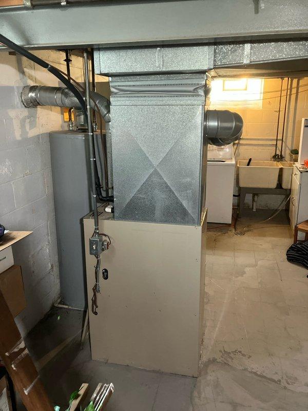 Performed comprehensive inspection and cleaning of 10+ year old cooling system located in basement. Evaluated HVAC unit condition, including ductwork connections and airflow components, and completed full system cleaning as requested. Documented exterior electrical service installation and interior equipment configuration with photographic records for reference.
