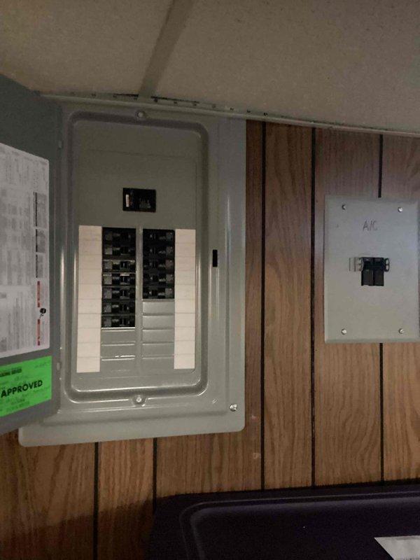 Provided estimate for complete air conditioning system replacement in basement location. Existing 10+ year old unit is non-operational and requires full replacement. Evaluated electrical service panel and dedicated A/C disconnect, assessed installation location and existing thermostat system for compatibility with new equipment. Photographed current electrical infrastructure and control systems to determine proper sizing and specifications for natural gas furnace integration with new cooling system.