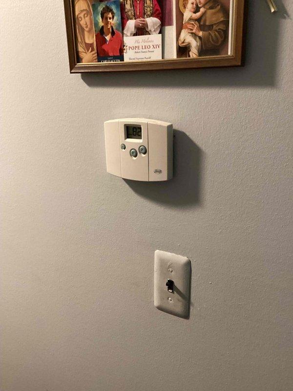 Provided estimate for complete air conditioning system replacement in basement location. Existing 10+ year old unit is non-operational and requires full replacement. Evaluated electrical service panel and dedicated A/C disconnect, assessed installation location and existing thermostat system for compatibility with new equipment. Photographed current electrical infrastructure and control systems to determine proper sizing and specifications for natural gas furnace integration with new cooling system.