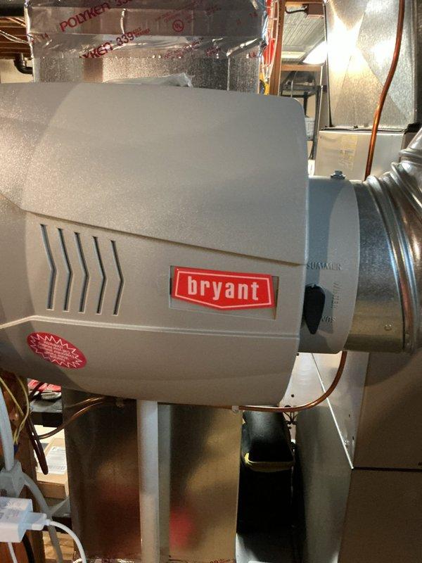 Completed comprehensive Gold AC Inspection on residential Bryant HVAC system with air handler located in basement. Performed full system evaluation including inspection of outdoor condensing unit with refrigerant line connections, indoor air handler components, and integrated Bryant humidifier system. All equipment found operating properly with no service issues identified at time of inspection.