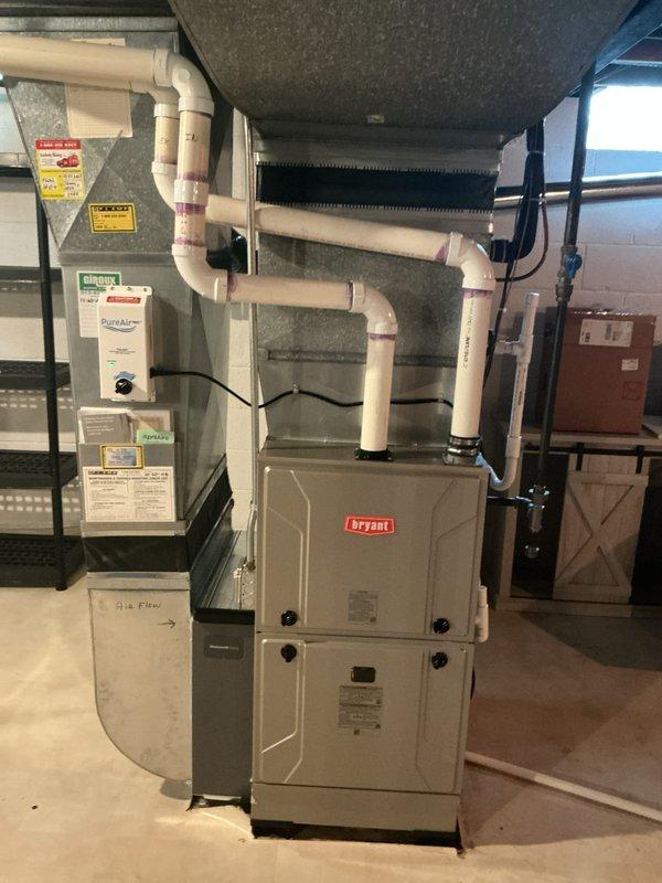 Completed full HVAC system estimate for residential basement installation involving 10+ year old air conditioning equipment. Assessed existing Bryant furnace installation with associated PVC condensate drainage system, humidifier integration, and ductwork configuration. Evaluated current system components including plenum assembly, evaporator coil, and electrical connections to provide comprehensive replacement options for aging AC system.