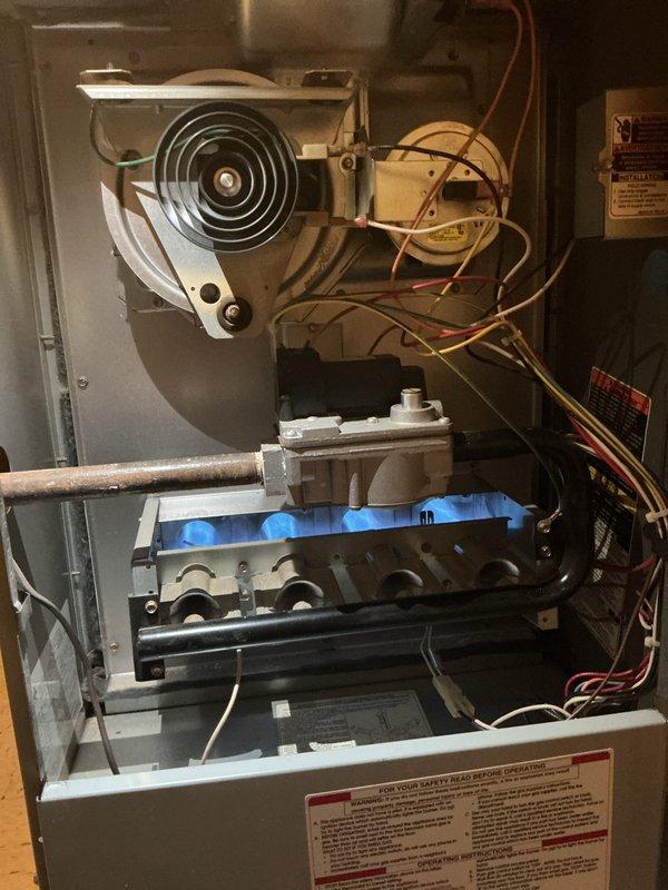 Performed comprehensive AC tune-up on 10-year-old outdoor condenser unit and 15-year-old gas furnace system located in basement. Conducted visual inspection of both units, verified proper operation of gas valve and burner assembly with clean blue flame pattern across all burner ports, and confirmed draft inducer motor functioning correctly. Inspected outdoor condenser unit positioned on concrete pad, checked fan operation and grille condition, verified refrigerant lines and electrical connections secure, and assessed overall system performance. Both heating and cooling components operating within normal parameters with no immediate concerns identified. System maintained per manufacturer specifications with no deficiencies noted during inspection.