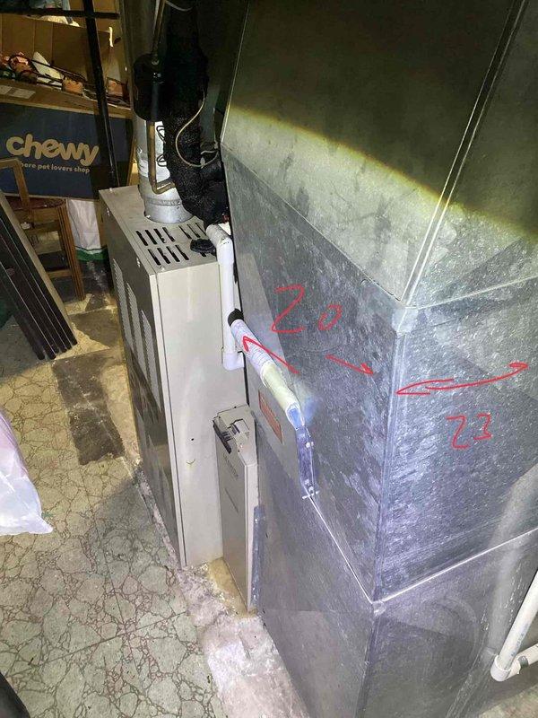 Conducted on-site evaluation for replacement of 27-year-old furnace and existing air conditioning system located in basement. Assessed current HVAC equipment configuration, including furnace cabinet, ductwork system, and condensate drainage piping. Documented existing installation measurements and specifications, noting duct sizing marked at 20" and 22" sections. Photographed equipment layout showing metal air handler unit, white furnace cabinet with ventilation slots, associated PVC condensate lines, and black refrigerant line sets. Evaluated ceiling access point and ductwork routing above suspended ceiling tiles for future installation considerations. Provided comprehensive replacement quote for new furnace and air conditioner system based on current equipment specifications and installation requirements.