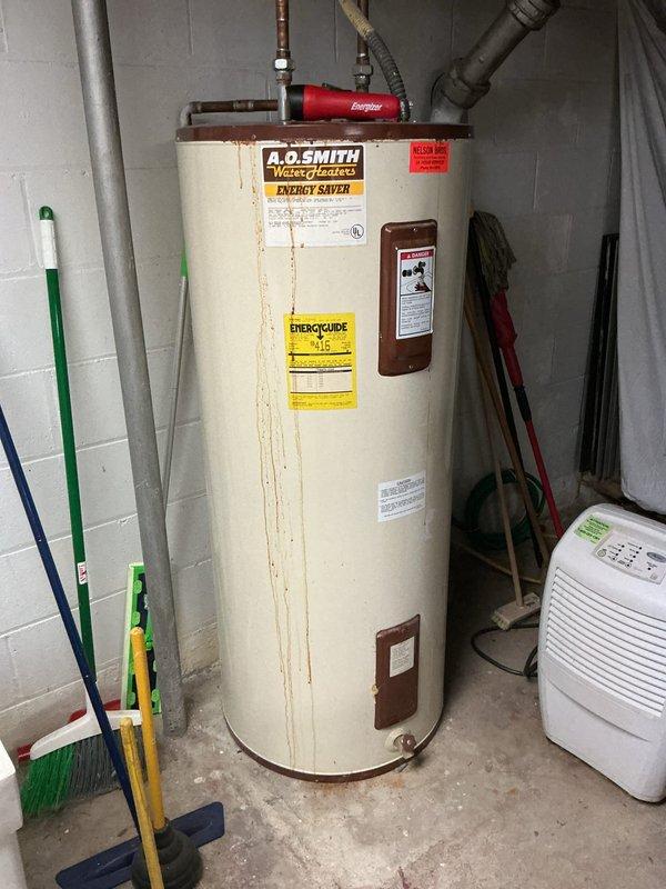 Assessed non-functional 80-gallon electric water heater showing significant rust deterioration and confirmed power vent configuration with dedicated electrical disconnect. Documented existing A.O. Smith Energy Saver unit installation including copper supply lines, electrical connections, and mechanical room conditions. Prepared estimate for replacement options comparable to requested 80-gallon hybrid heat pump water heater, taking into account potential installation limitations in existing space.