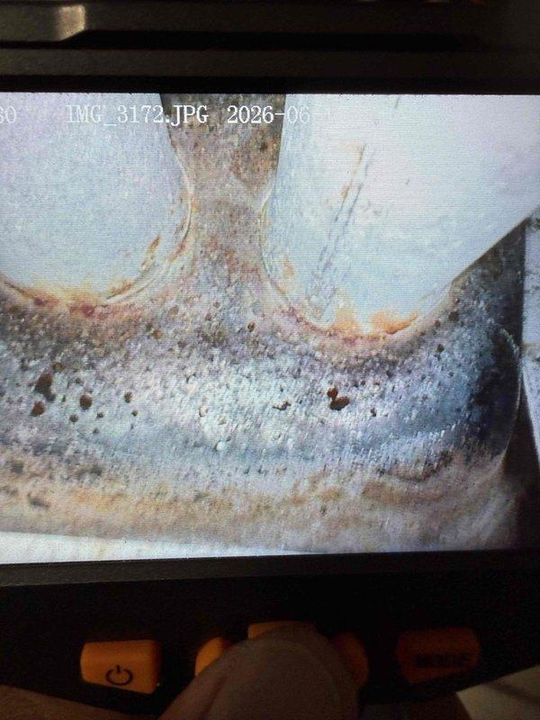 Responded to no cooling complaint on 23-year-old air conditioning system located in basement. Upon arrival, found outdoor condensing unit inoperative with condenser fan motor not running. Performed diagnostic testing using clamp meter, which revealed no current draw to compressor, reading 0.004 amps. Visual inspection revealed extensive corrosion and rust deterioration on condenser cabinet panels, indicating prolonged exposure to moisture and environmental elements. Paint coating severely compromised with widespread flaking, peeling, and pitting across metal surfaces. Accessed electrical compartment and inspected wiring connections and components. Given the advanced age of equipment at 23 years and significant structural deterioration observed, advised homeowner that system has exceeded typical service life expectancy of 15-20 years. Discussed repair versus replacement options, noting that multiple component failures are common in units of this age and condition. Recommended full syste