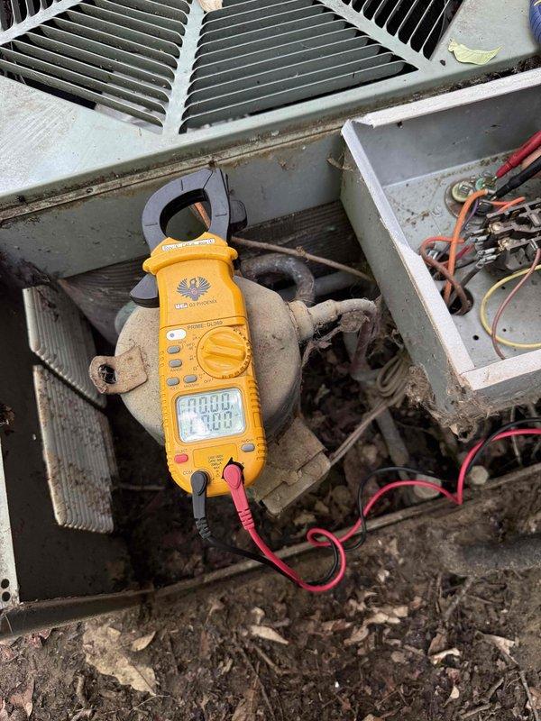 Responded to no cooling complaint on 23-year-old air conditioning system located in basement. Upon arrival, found outdoor condensing unit inoperative with condenser fan motor not running. Performed diagnostic testing using clamp meter, which revealed no current draw to compressor, reading 0.004 amps. Visual inspection revealed extensive corrosion and rust deterioration on condenser cabinet panels, indicating prolonged exposure to moisture and environmental elements. Paint coating severely compromised with widespread flaking, peeling, and pitting across metal surfaces. Accessed electrical compartment and inspected wiring connections and components. Given the advanced age of equipment at 23 years and significant structural deterioration observed, advised homeowner that system has exceeded typical service life expectancy of 15-20 years. Discussed repair versus replacement options, noting that multiple component failures are common in units of this age and condition. Recommended full syste