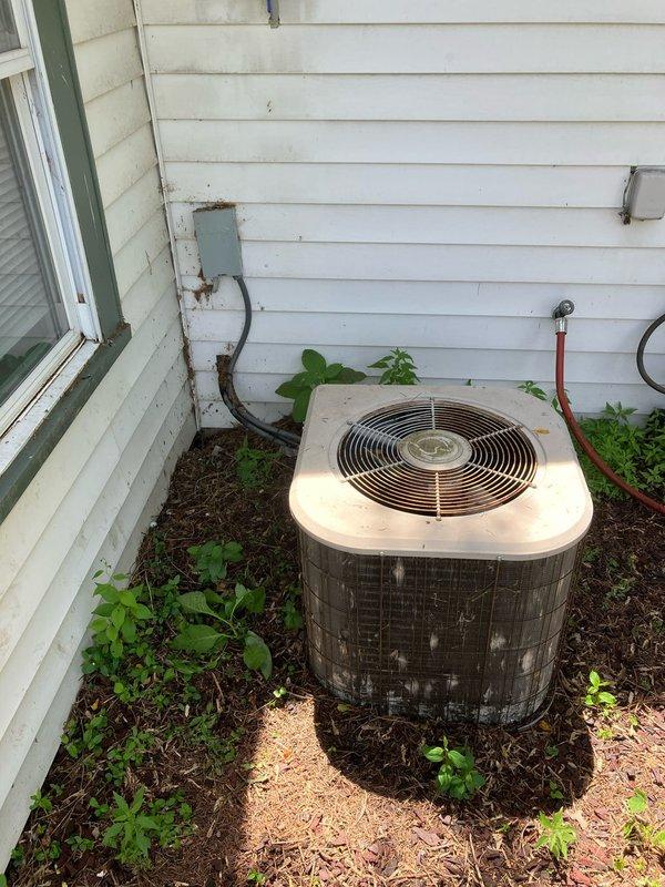 Completed full system replacement estimate for residential HVAC equipment. Evaluated existing outdoor condenser unit positioned against exterior wall and assessed interior Honeywell thermostat with protective cover for replacement specifications. Documented current system configuration and equipment condition to provide comprehensive quote for complete heating and cooling system installation at two properties scheduled for same appointment.